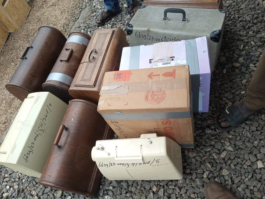 Sewing machines and protective cases laid together at Tema Harbour.